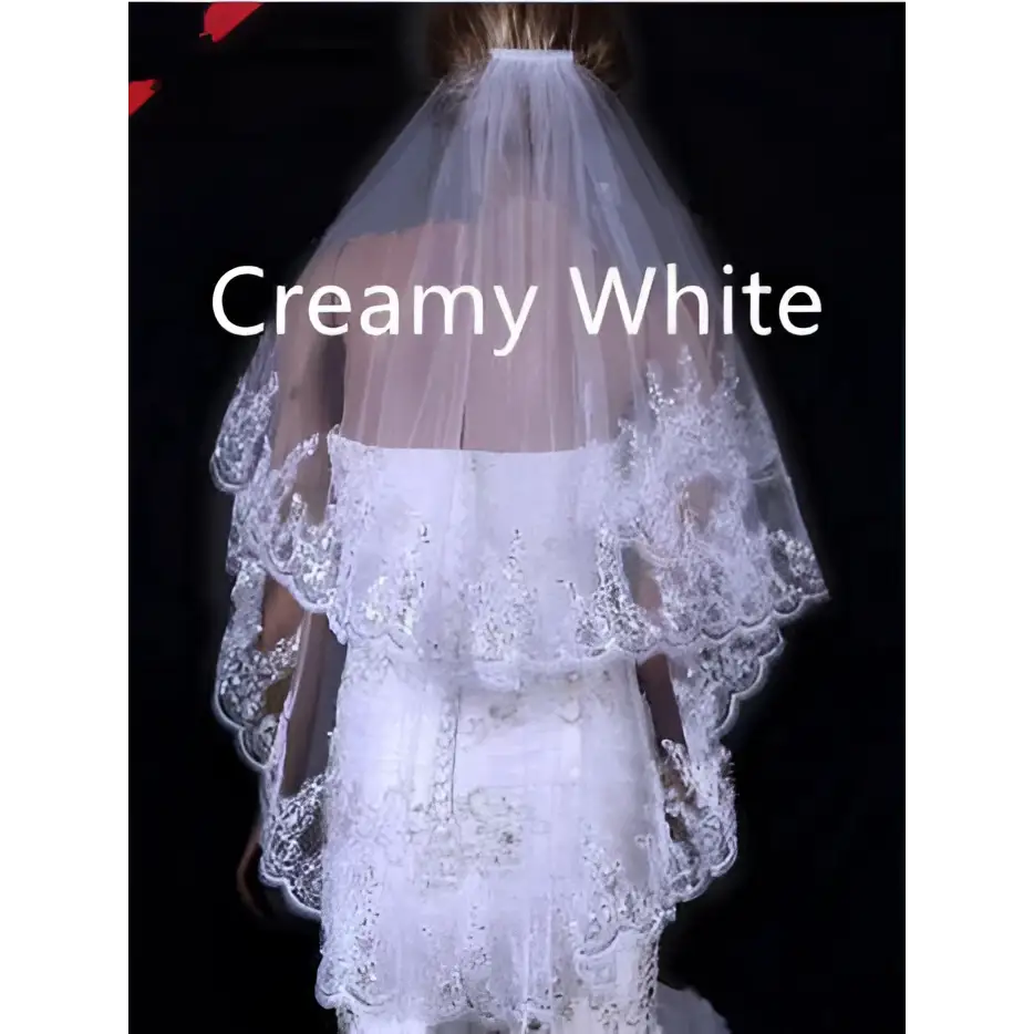 Creamy white two layer bridal sequined polyester veil with tiered lace, floral embroidery, and scalloped edges