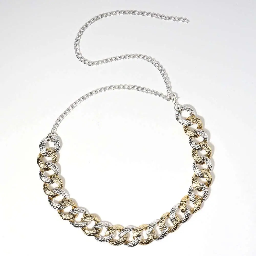 A bold two tone chain summer body jewelry belt featuring a thick interlocking gold and silver link design