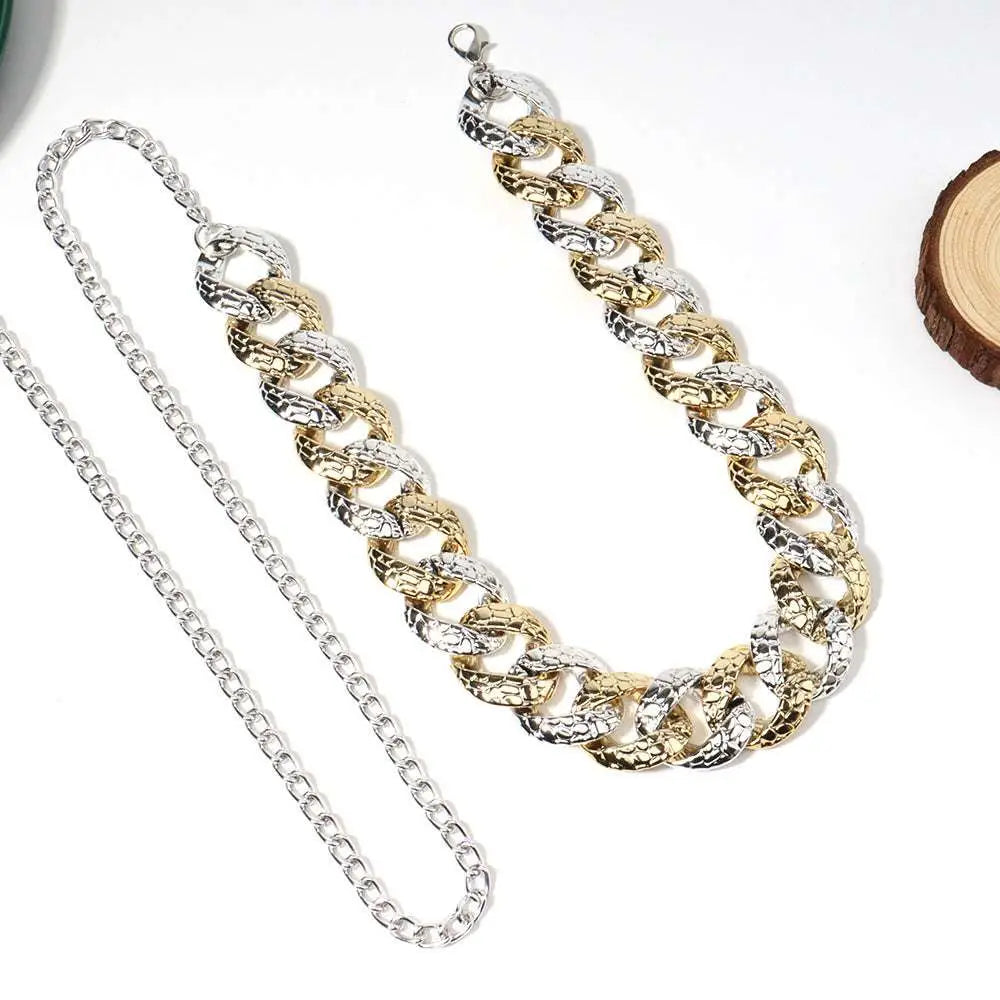 Two tone chain summer body jewelry belt featuring textured gold and silver interlocking links