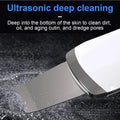 White and silver ultrasonic skin scrubber exfoliating device with sleek modern design and dust-proof silicone cover
