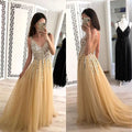 A shimmering gold v-neck sequined floor-length dress with intricate beaded bodice and flowing layered tulle skirt