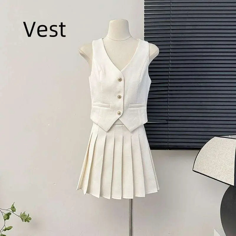 White v-neck vest with three gold buttons paired with high waist pleated apricot waistcoat skirt two-piece set