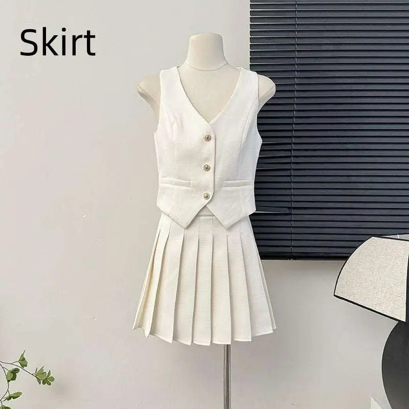 White high waist pleated skirt and apricot v-neck vest two-piece set with gold-toned buttons in crisp fabric