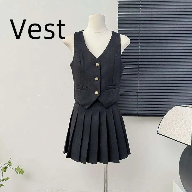 Black sleeveless v-neck vest with gold buttons paired with high waist pleated skirt in a two-piece apricot waistcoat set