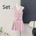 A soft pink apricot waistcoat v-neck vest and high waist pleated skirt set with textured fabric and gold buttons