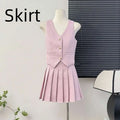 A soft pink high waist pleated skirt with matching apricot waistcoat v-neck vest featuring gold buttons and pockets