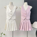 A white and pale pink high waist pleated skirt two-piece set with a v-neck vest and gold-toned apricot waistcoat buttons