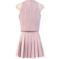 A soft pink v-neck vest and high waist pleated skirt two-piece set featuring a structured bodice and apricot waistcoat style