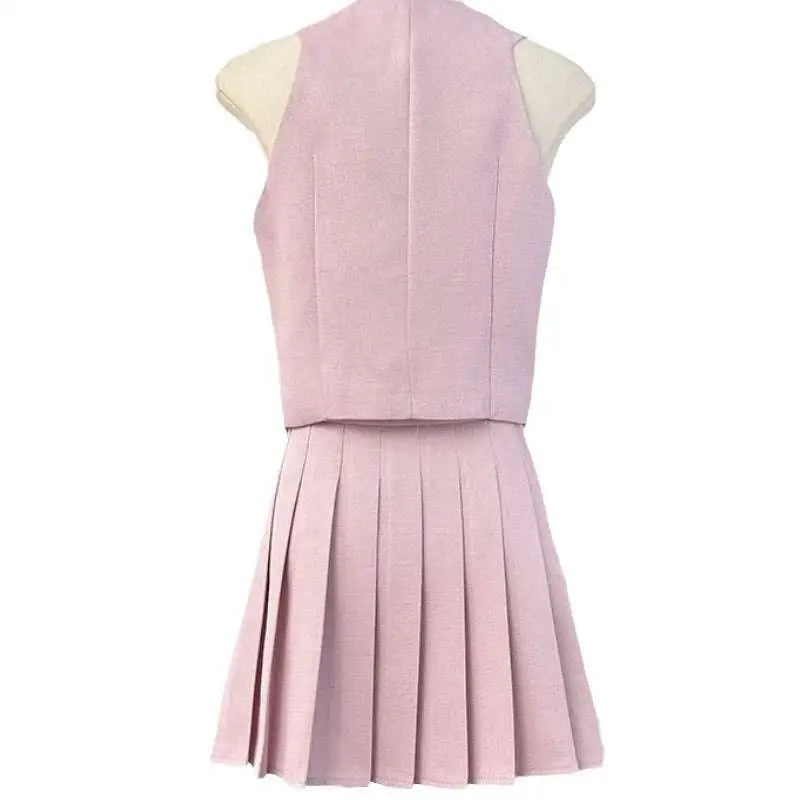 A soft pink v-neck vest and high waist pleated skirt two-piece set featuring a structured bodice and apricot waistcoat style