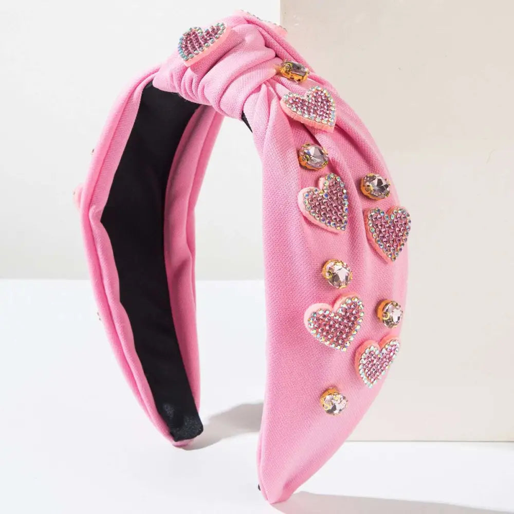 Pink valentines day headband with knotted love accessories featuring sparkling heart-shaped rhinestones and gold embellishments