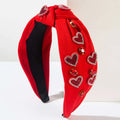 Valentines day headband in red velvet with knotted love accessories featuring sparkling heart-shaped gemstones