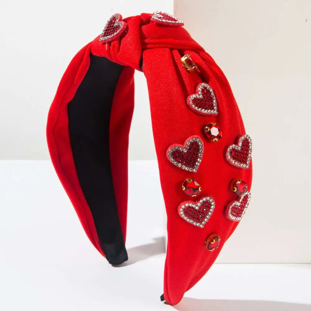 Valentines day headband in red velvet with knotted love accessories featuring sparkling heart-shaped gemstones