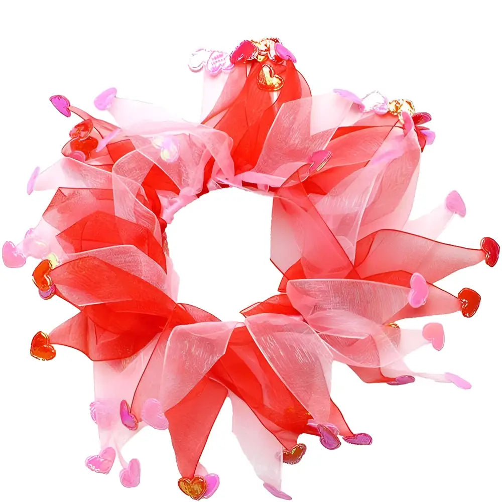 A festive red and pink sheer organza valentine’s day pet wreath adorned with heart charms for dog party decorations