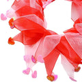 A festive red and pink sheer organza pet scarf with dangling heart charms for valentine’s day pet and dog party decorations