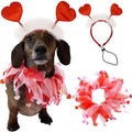 A dachshund wearing a valentine’s day pet scarf in red and pink sheer organza with heart embellishments for dog party decorations