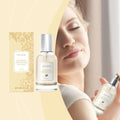 A sleek transparent vanilla body hair perfume spray bottle with silver nozzle containing light-colored liquid