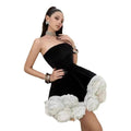 Black velvet strapless dress with voluminous white flower pettiskirt french ruffles detail at the skirt