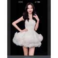 White velvet strapless dress with fitted bodice and voluminous skirt featuring layered flower pettiskirt french ruffles