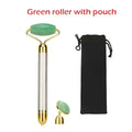 Green jade vibra beauty vibrating gemstone roller with gold handle and replacement head next to black drawstring pouch