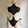Black one-piece swimsuit with halter neckline and waist cutout featuring circular ring detail and side ties for vibrant blue cutout look