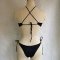 Back view of a black string bikini with crisscross back and side ties in a vibrant blue cutout color swimsuit design