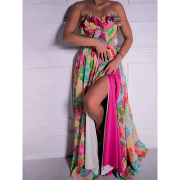 A vibrant strapless floral print maxi dress with a ruffled bodice in pink green yellow and blue hues
