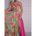 Vibrant strapless floral print maxi dress in bright pink fabric with ruffled bodice and high slit design