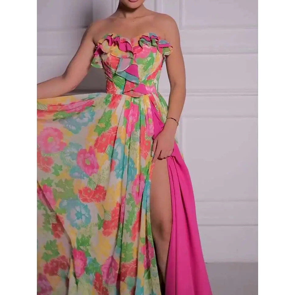 Vibrant strapless floral print maxi dress in bright pink fabric with ruffled bodice and high slit design