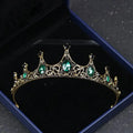 Vintage baroque alloy tiara with an ornate crown-like design featuring gold filigree and emerald green and black gemstones