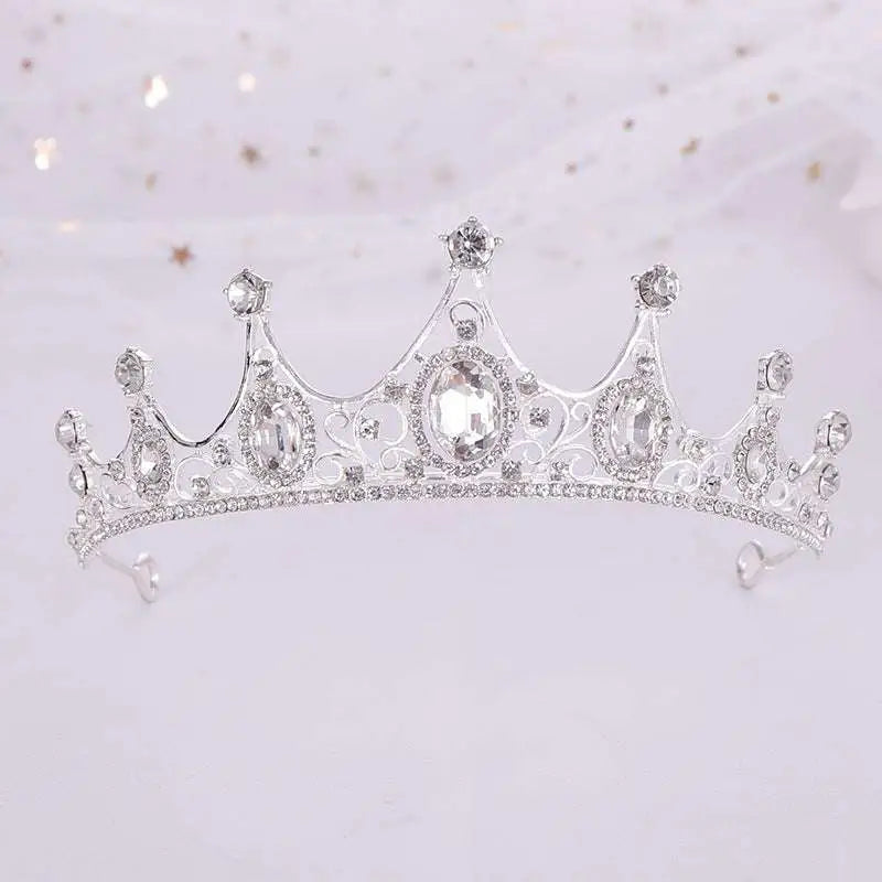 A vintage baroque alloy tiara with a sparkling silver finish, clear crystals, and ornate crown-like filigree detailing