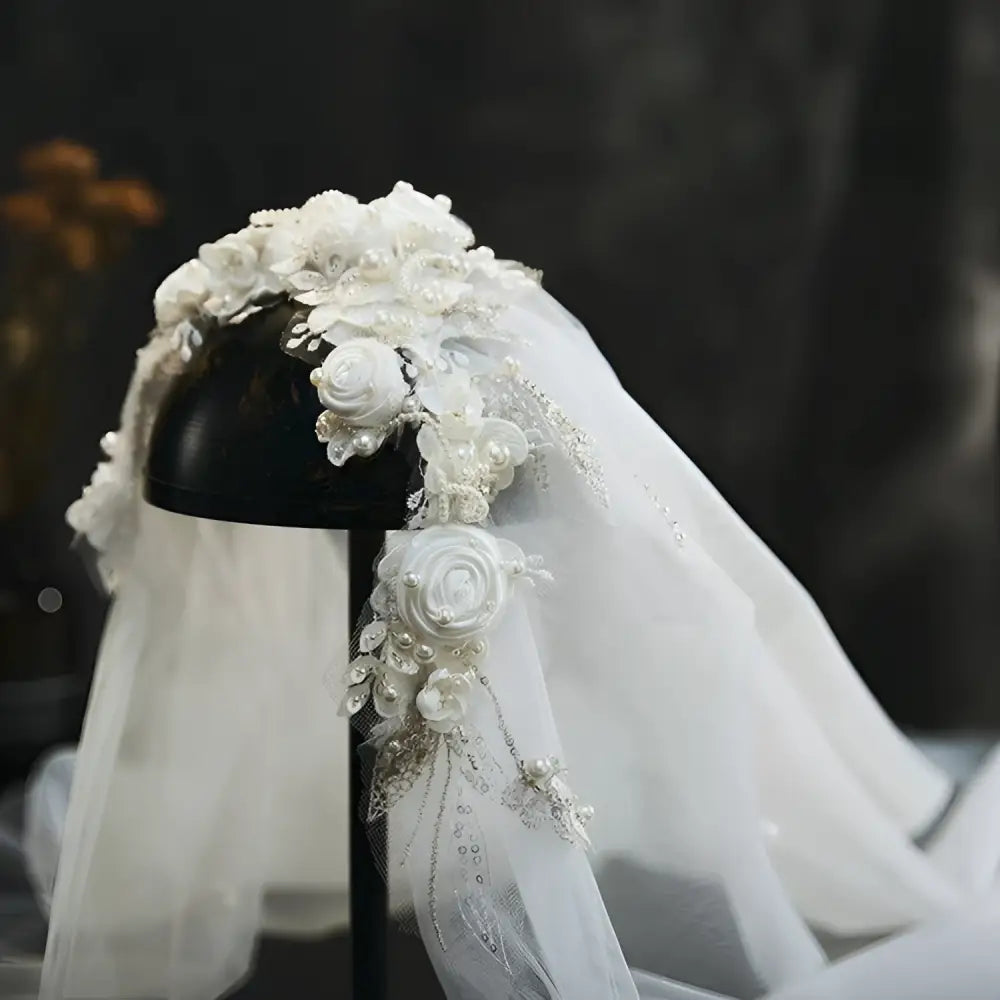 Elegant white bridal veil featuring vintage beaded lace petal headdress with delicate lace pearls and floral embellishments