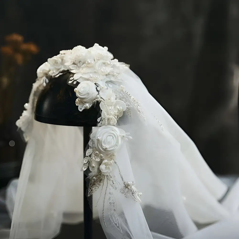 Elegant white bridal veil with vintage beaded lace petal headdress featuring embroidered roses and sparkling pearls