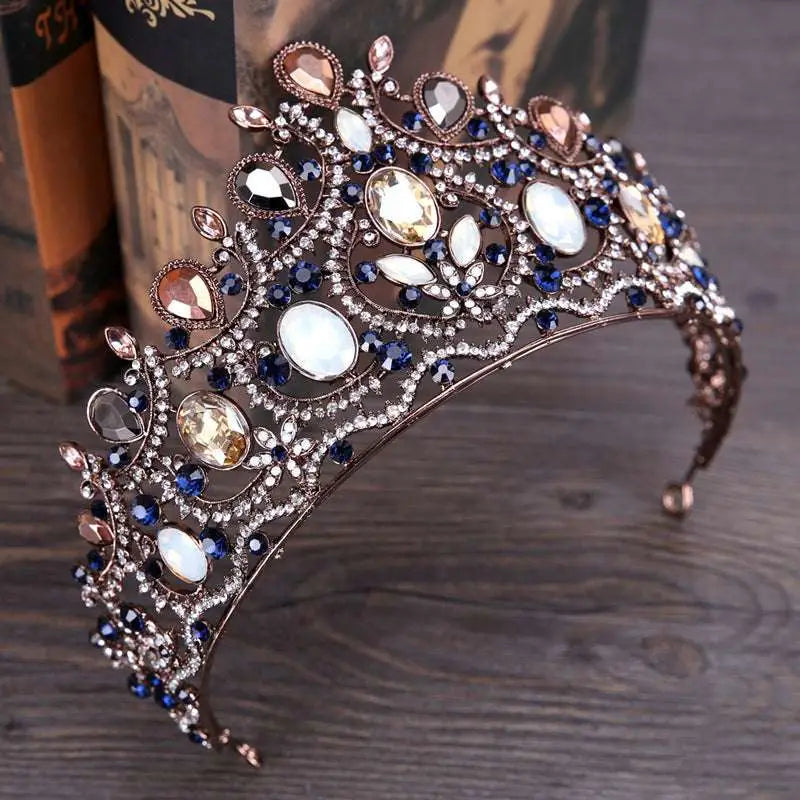 Ornate vintage elegant bridal crown tiara with deep blue amber and white crystals in a metallic diamond bridal crown setting