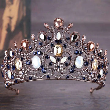 An ornate vintage elegant diamond bridal crown tiara featuring deep blue and clear crystals in silver filigree
