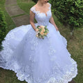 A vintage lace white wedding dress with delicate lavender main fabric and intricate floral train detailing