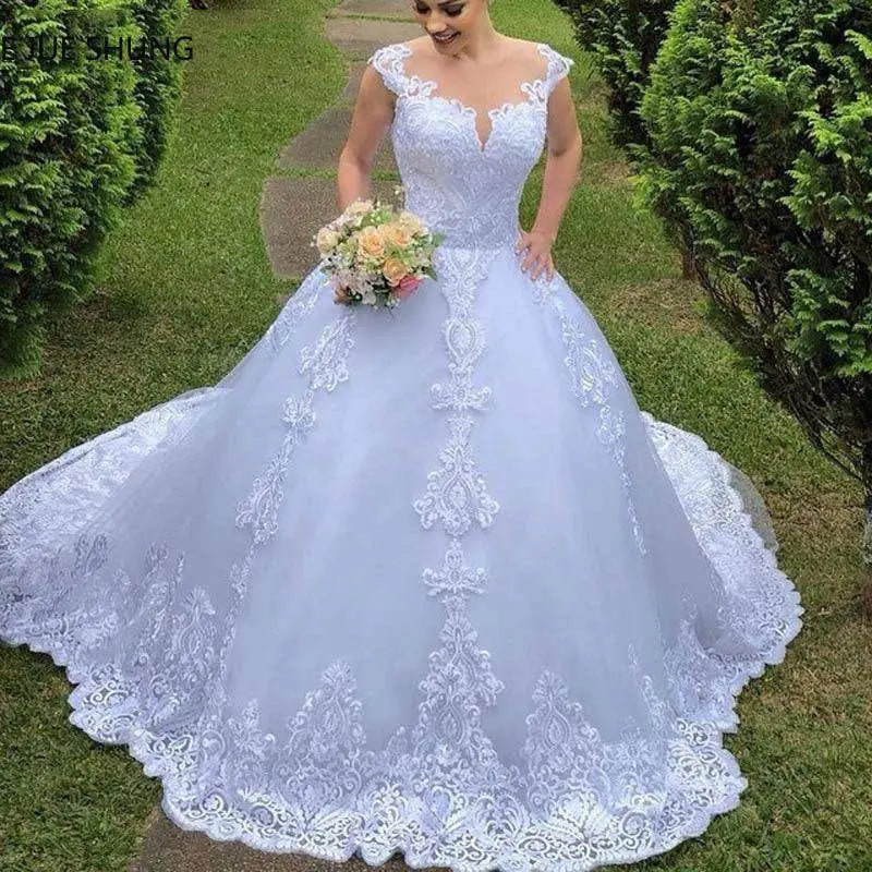 A delicate lavender vintage lace wedding dress with intricate white lace floral train and voluminous main fabric skirt