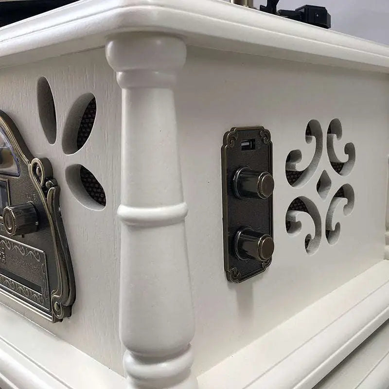 Vintage white gramophone with brass horn and ornate black cabinet detailing for classical living room stereo use