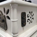 Vintage white gramophone with ornate metal accents and decorative cutouts for classical living room stereo setup