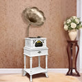 Vintage white gramophone with brass horn and ornate black cabinet detailing for classical living room stereo use
