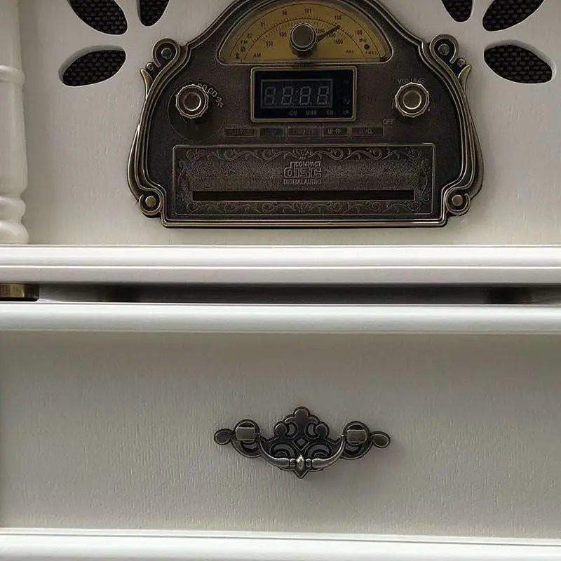 Antique-style silver-plated cd player with ornate detailing and digital display for vintage white gramophone classical living room