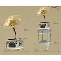 Vintage white gramophone with gold ornate floral detailing on cabinet for classical living room stereo use