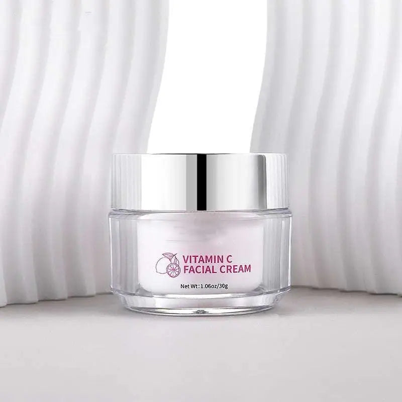 A clear glass jar with a silver lid containing white vitamin c brightening face cream by Royale Essence Lux 30g