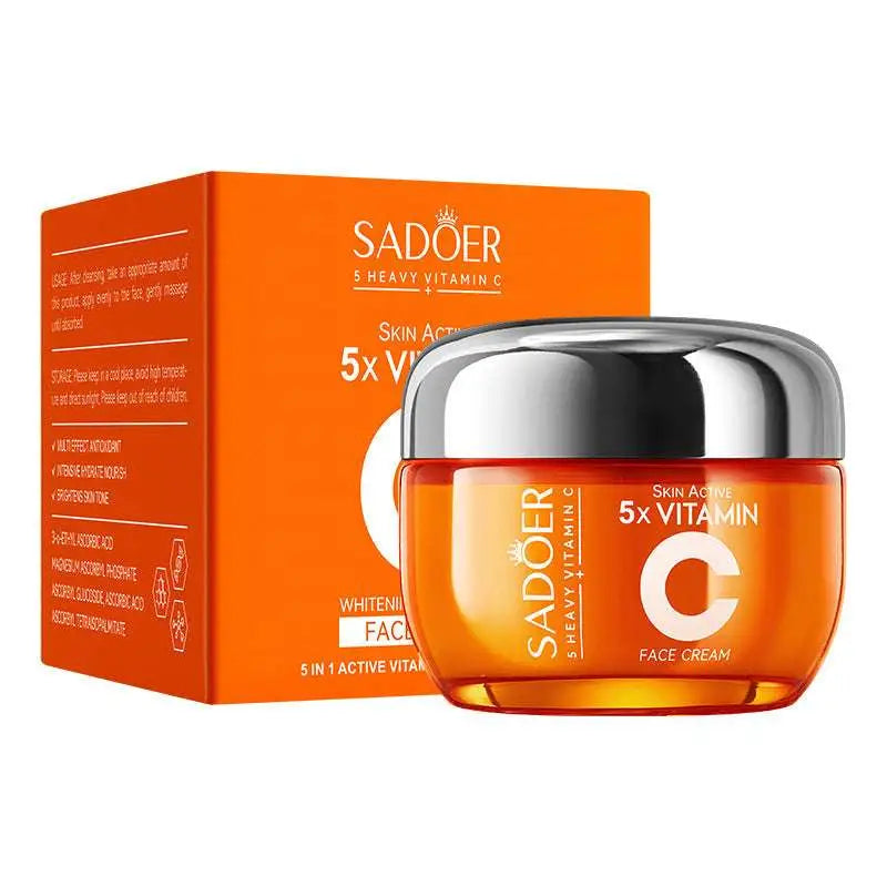 Sadoer 5x vitamin c face cream in a glossy orange jar with silver lid in an orange rectangular vitamin c whitening skin care box