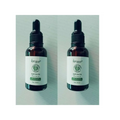 Two identical vitamin e rich hair care essential oil bottles with dark amber glass and black dropper caps by lansiyi