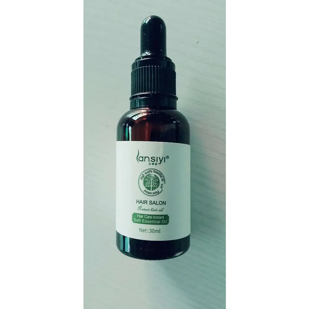 A dark amber glass bottle of lansiyi vitamin e rich hair care essential oil with a black dropper cap for hair salon use
