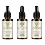 Three amber glass bottles of vitamin e rich hair care essential oil with black dropper cap and silver label with green text