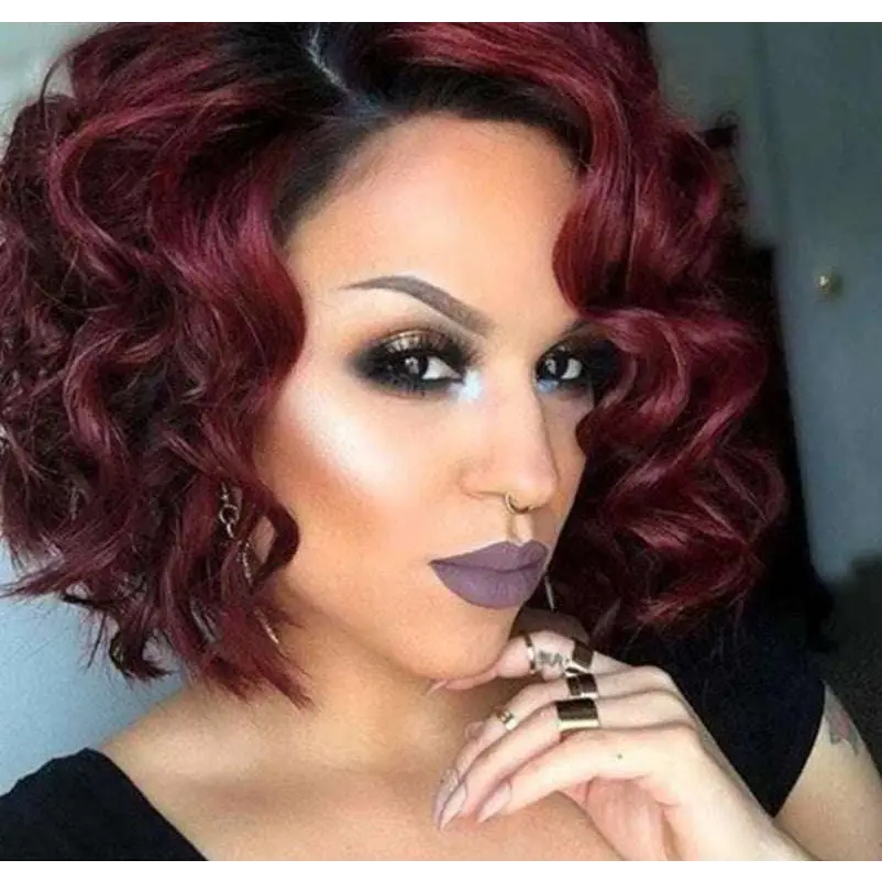 A woman wearing a voluminous burgundy curly European beauty wig made with high temperature wire fibers and bold makeup
