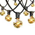 Warm waterproof string lights featuring clear glass globes with warm tones and black metal clips and cords