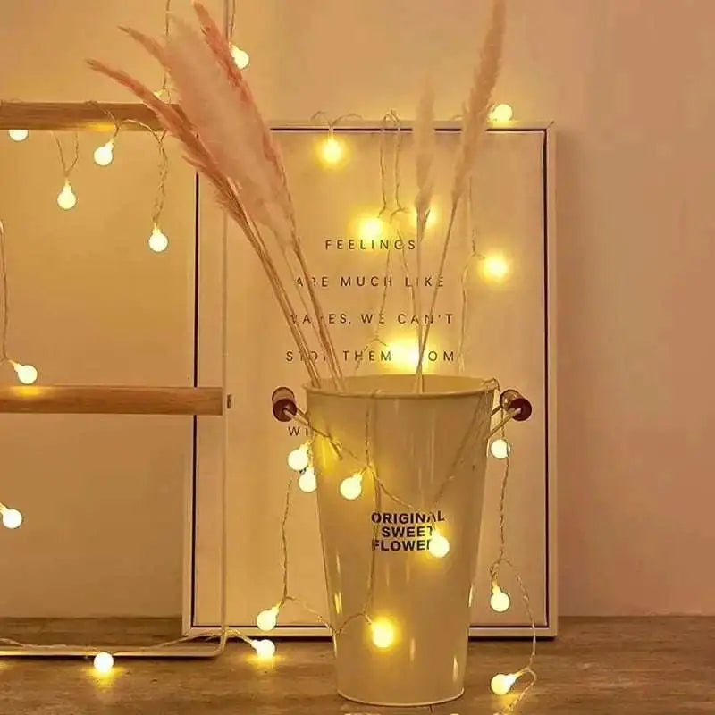 Cream-colored cylindrical bucket with original sweet flower text and red handles containing warm yellow sunshine pearl lights led pearls