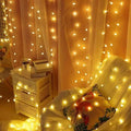 Warm yellow sunshine pearl lights with led pearls draped over sheer curtains and a cozy chair creating an inviting ambiance